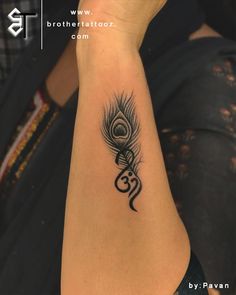 a woman's arm with a peacock tattoo on it