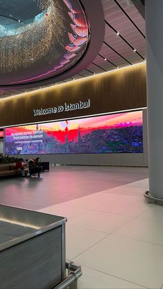 an airport lobby with people waiting for their luggage to be taken off the conveyor belt