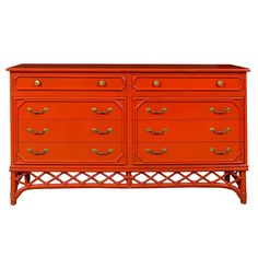 an orange dresser with gold handles and drawers on it's sides, against a white background