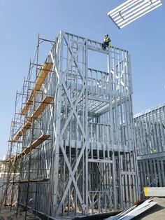 a man on a scaffold working on a building