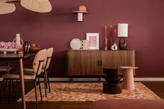 a dining room with purple walls and wooden furniture