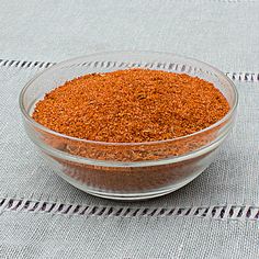 a glass bowl filled with spices on top of a table