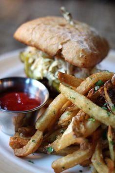 a sandwich and fries on a plate with ketchup