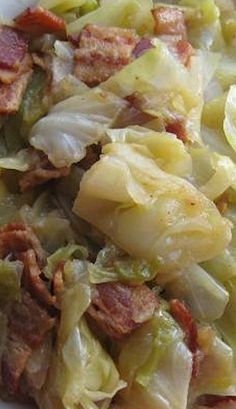 a white plate topped with cabbage and meat