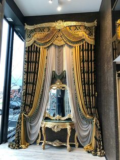 an ornately decorated room with gold and black drapes on the window sill