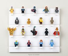 lego minifigures are displayed on a white shelf