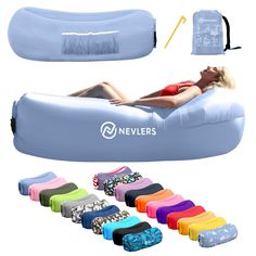 a woman laying on top of an inflatable mattress next to many different items