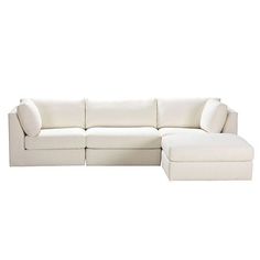 a white sectional couch with pillows on it's back and the seat folded out