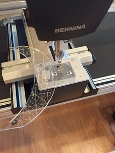 a machine that is sitting on top of a wooden floor with the word bernia in front of it