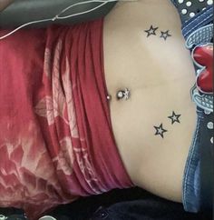 a woman with stars tattoo on her stomach