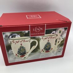 two coffee mugs in a red box with christmas tree designs on the front and sides