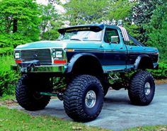 a large blue truck parked on top of a driveway