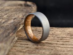 a wooden ring sitting on top of a piece of wood