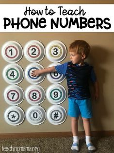 a young boy standing in front of a phone number poster with the words how to teach phone numbers