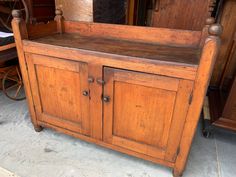 an old wooden cabinet sitting on top of a floor