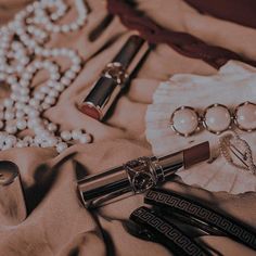 an assortment of jewelry and pearls on a cloth