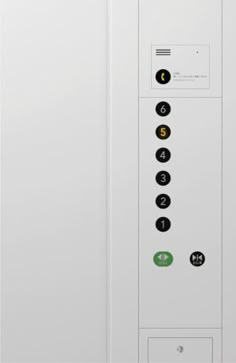 the back side of a white door with buttons and numbers on it