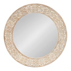 a round mirror with an intricate design on it