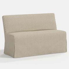 a beige striped couch sitting on top of a white floor