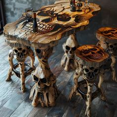 three stools made out of wood with skulls on them