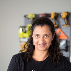 a woman wearing a black shirt and smiling at the camera