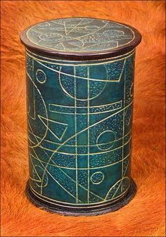 a blue box sitting on top of a brown fur covered floor next to a wooden table