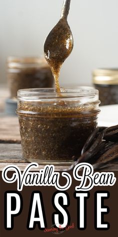 vanilla bean paste is being poured into a jar