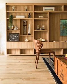 a living room filled with furniture and wooden shelves