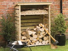 a pile of wood sitting next to a firewood rack