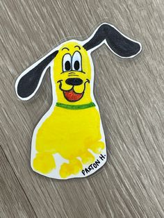 a yellow dog with black ears on it's head