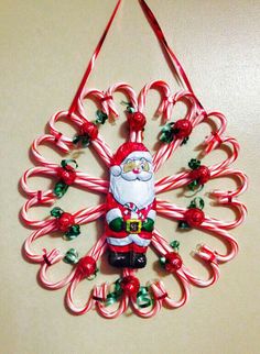 a christmas ornament hanging on a wall with candy canes