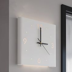 a clock that is on the wall next to a window with curtains behind it,