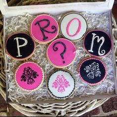 decorated cookies in a basket with the letters q, p, m, and d