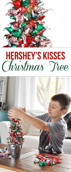 a young boy decorating a christmas tree with hershey's kisses on it