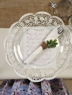 a table setting with place settings, napkins and silverware on top of it