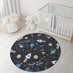 a baby's room with a crib and rug in the shape of a rocket ship