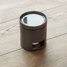 an empty cup sitting on top of a wooden table