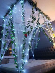 the bed is decorated with greenery and lights