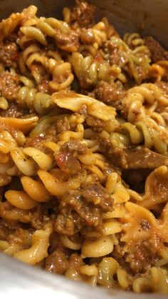 pasta with meat and sauce in a white bowl