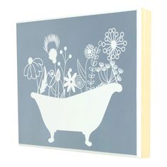 a white bathtub with flowers in it on a blue background