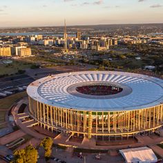 an aerial view of a stadium with the city in the background