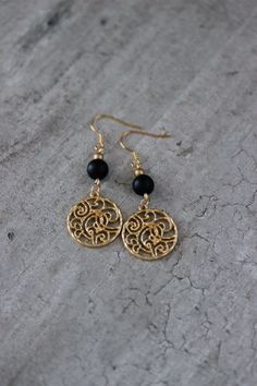 These beautiful geometric earrings was made of black matt onyx stone 8 mm beads, tiny gold tone czech glass beads, gold tone round charms and gold tone stainless steel earring hooks. Earring hooks are from nickel free and lead free metal. The total lenght of earrings is 60 mm including earring hooks. Other earrings of my shop you can see here: https://www.etsy.com/shop/NaTavelli?section_id=13757927 Thanks for visit! Black Beaded Round Earrings, Gold Onyx Jewelry With Black Beads, Minimalist Black Brass Jewelry, Gold Beaded Earrings With Black Beads As Gift, Nickel-free Black Brass Earrings, Gold Onyx Earrings For Pierced Ears, Black Wire Wrapped Drop Earrings, Adjustable Gold Beaded Earrings With Black Beads, Nickel-free Black Dangle Jewelry