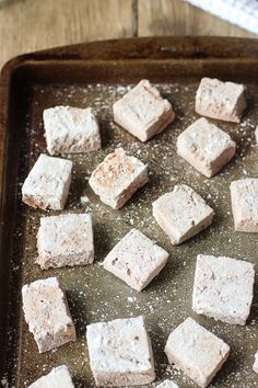 there are many cubes of food on the baking sheet