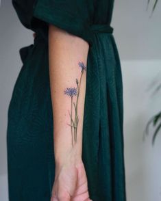 a woman's arm with purple flowers on it