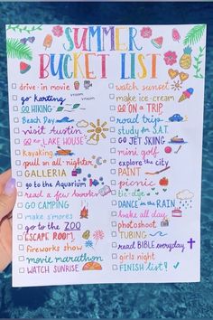 someone holding up a summer bucket list