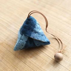 a small triangle shaped object sitting on top of a wooden table