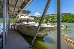 a boat is docked at the dock with another boat in the background