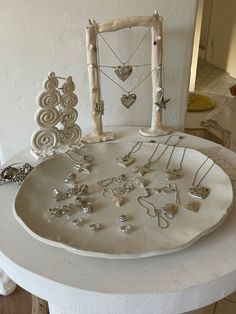 a white plate with jewelry on it sitting on a table