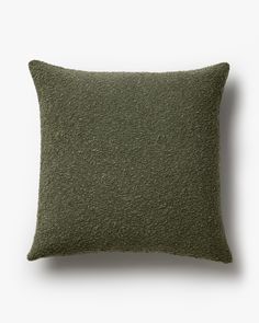 a green pillow on a white background