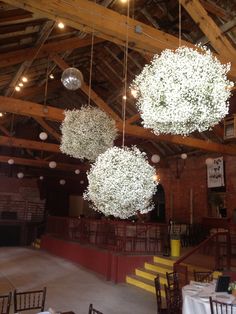 an image of a wedding venue with flowers hanging from the ceiling and chandeliers